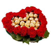 Buy Diwali Flowers in Mumbai incorporate with 24 Red Carnation Flowers with 24 Ferrero Rocher Chocolate in Heart Arrangement