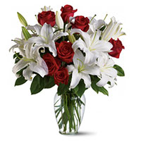 Place Order to Send Christmas Flowers to Mumbai along with 4 White Lily 12 Red Roses in Vase.